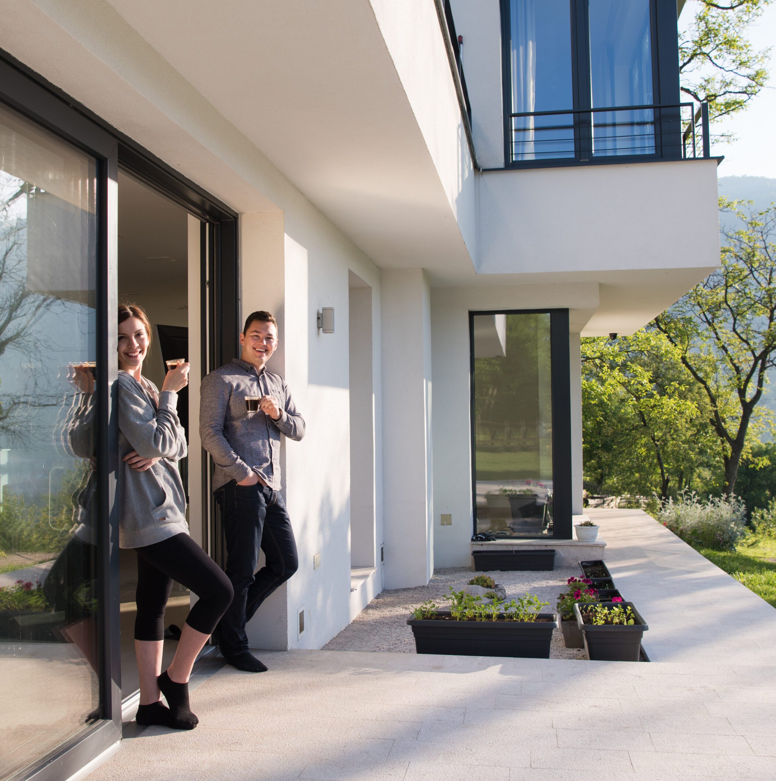 home-insurance-asset-protection-peace of mind - NexusInc Home insurance in Cyprus for residences, holiday & rental properties – couple enjoying coffee at modern home – NexusInc