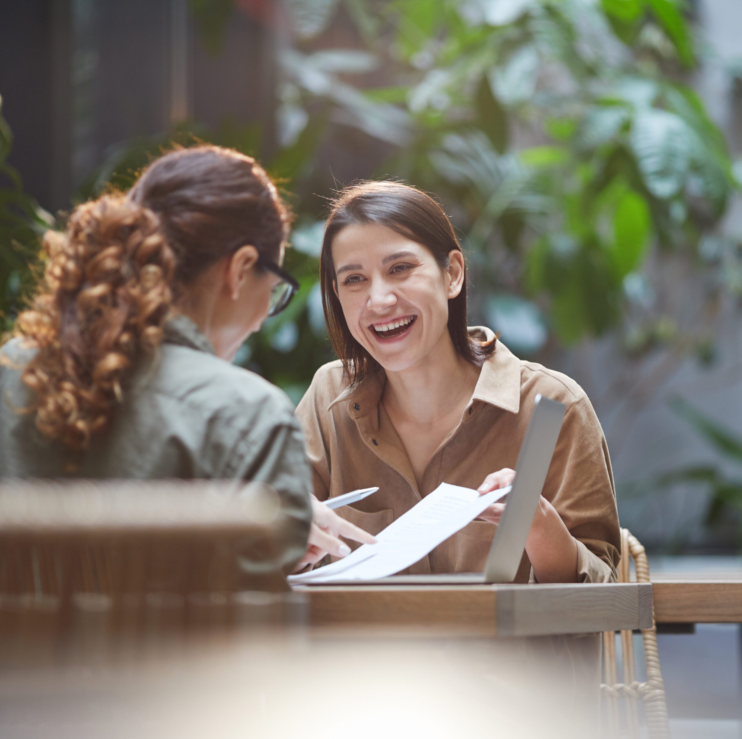 insurance-strategic-consultation-partnership-approach-Cyprus-NexusInc Insurance consultant from Nexus Inc having a casual meeting with a client at a café, discussing customized professional insurance solutions and partnership opportunities - NexusInc